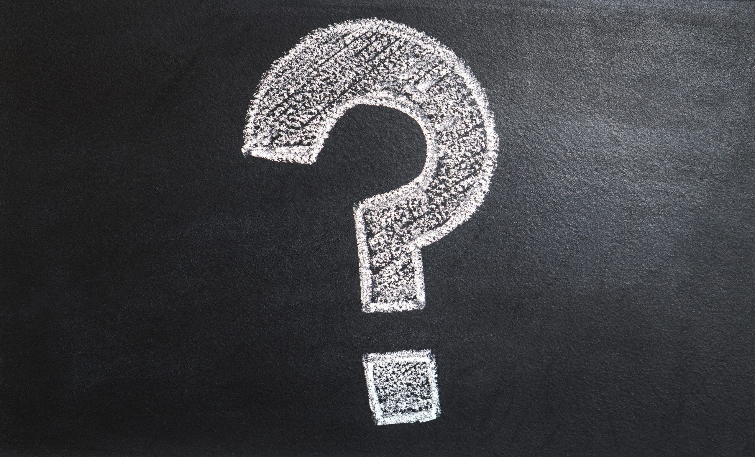 Question mark drawn in chalk on blackboard